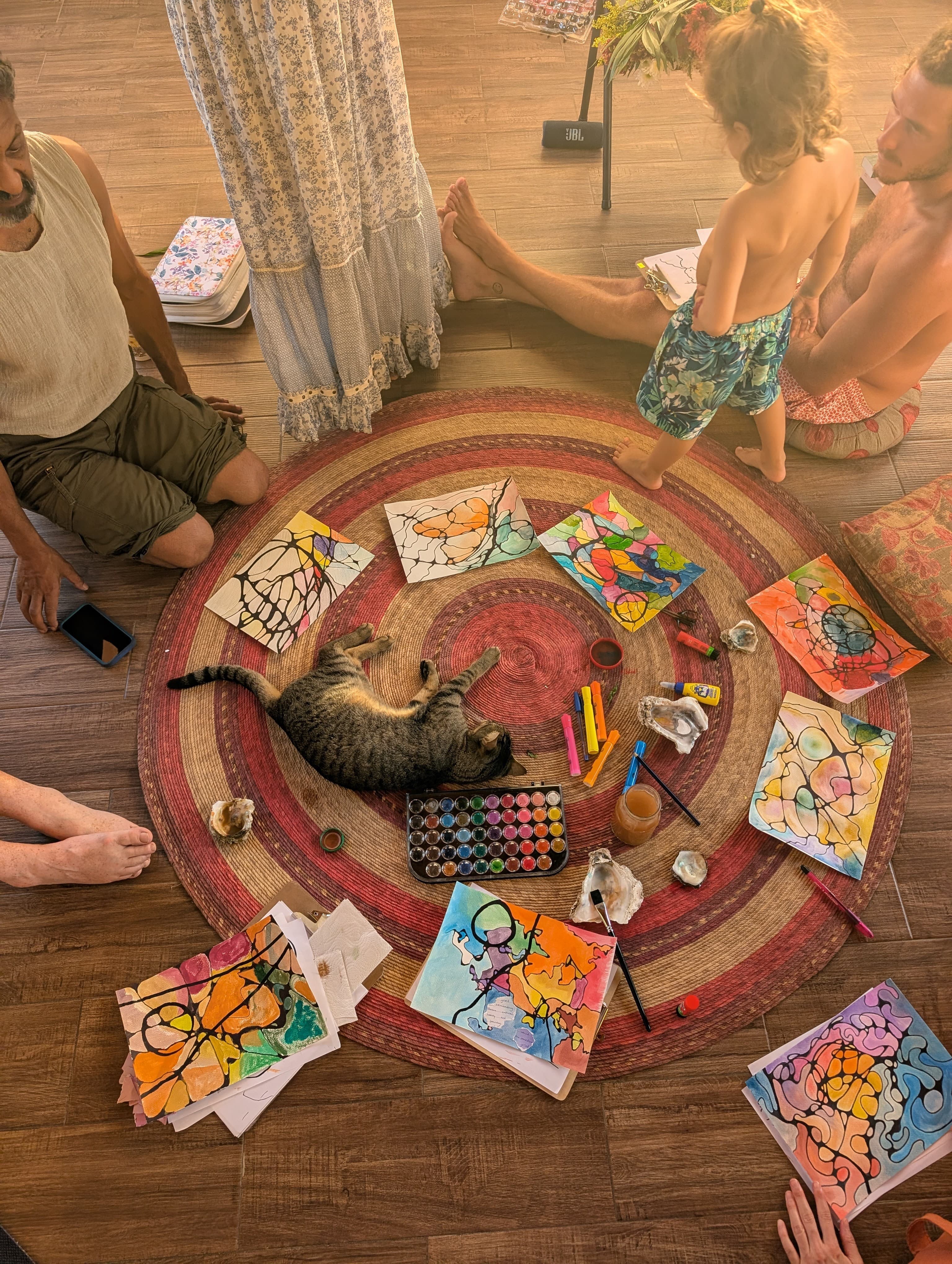 People gathered in a circle creating colorful neuro line drawings